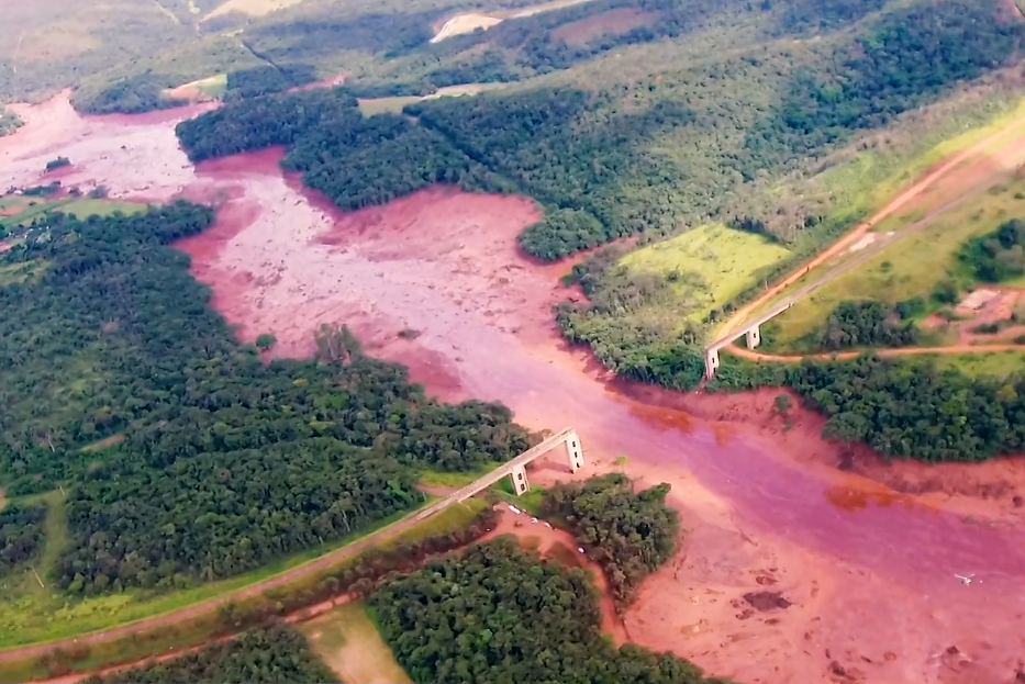 aerial view of red sludge flooded an entire river and vally and broke a bridge
