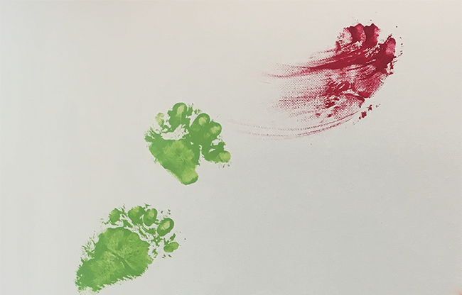 bear world breeding cubs and forcing paint on their paws to sell as art in the gift shop for $100; this image shows two green bear cub paw prints and one smeared red one.